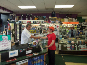 Two men shaking hands in Record Head store