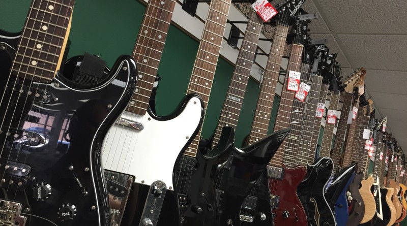 A display of many different guitars
