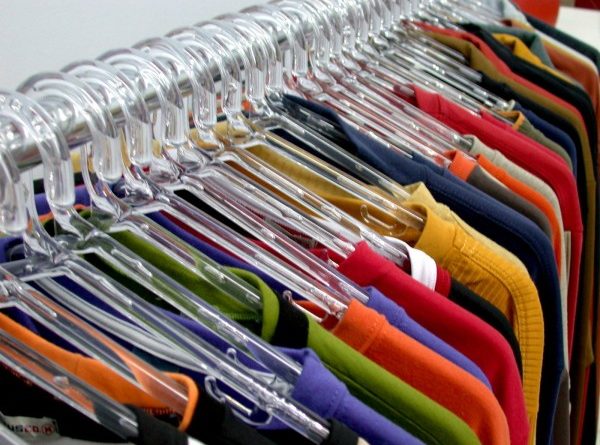 T-shirts hanging on hangers on a wrack