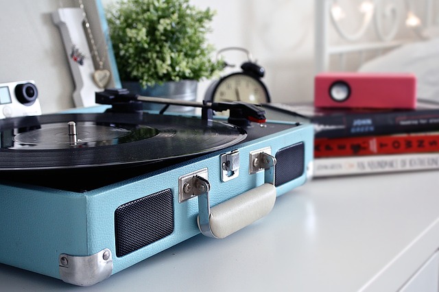 A vinyl record being played in a blue case