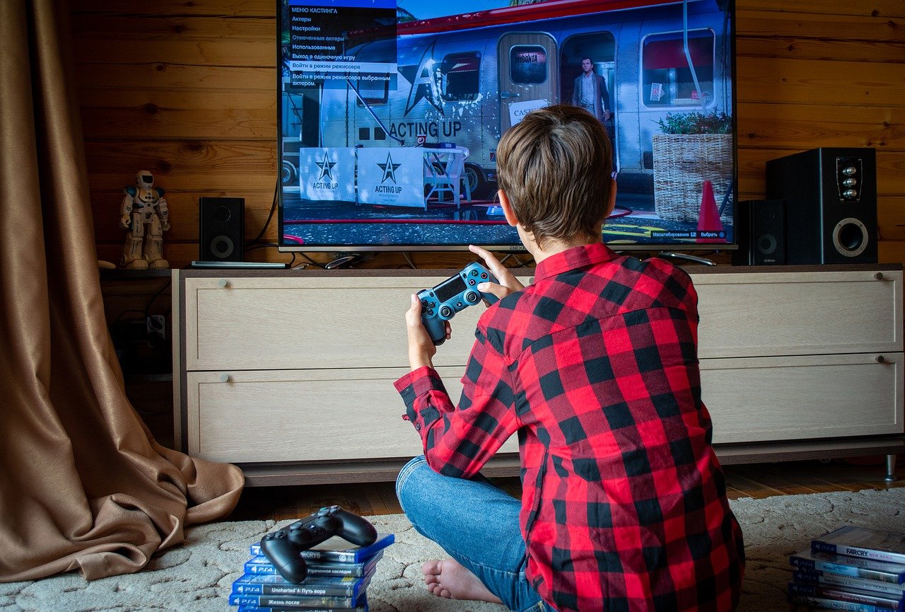 man in red shirt playing video games