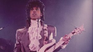 The singer Prince playing guitar at a concert