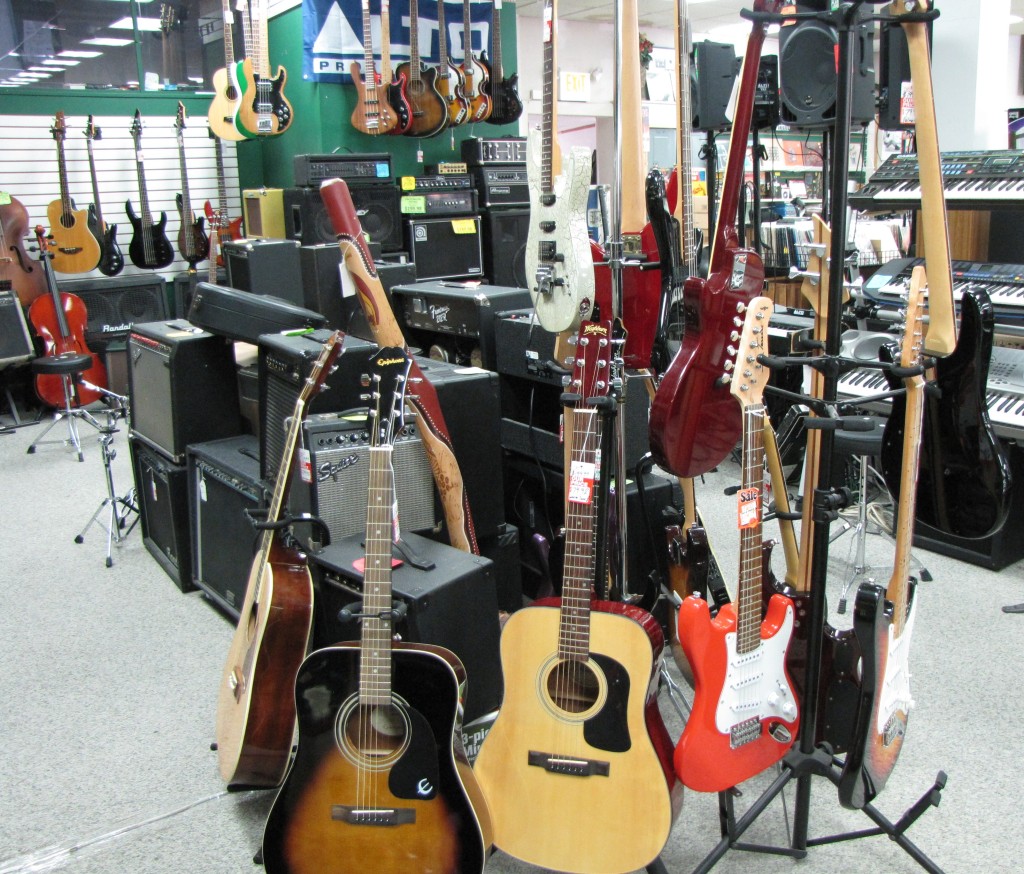 A shop display of guitars and other musical instruments