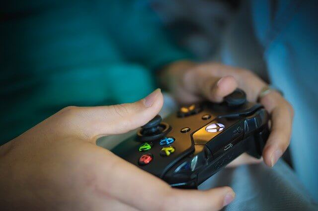 close up of a person using an XBox gaming controller