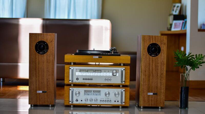 Speaker system set up next to two speakers with a record player on top