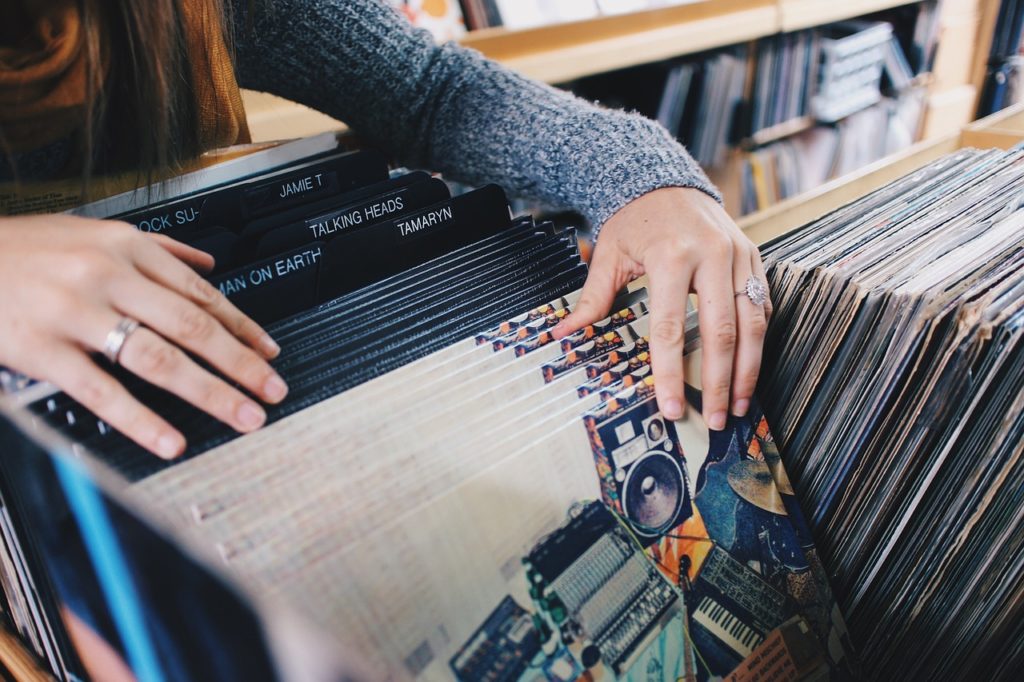 A lady paging through LP Vinyl Records in alphabetical order