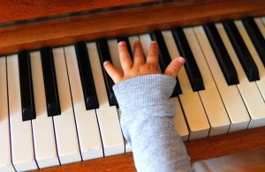 Infant playing a piano